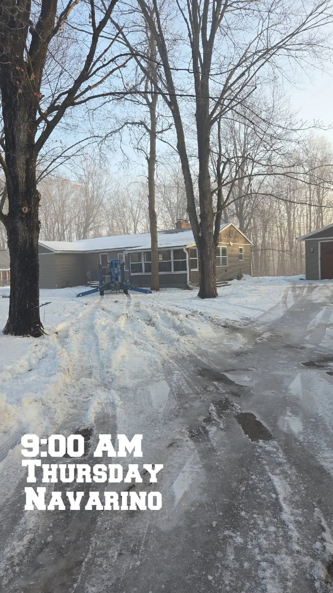 blue boom lift snowy driveway ranch house bare oaks